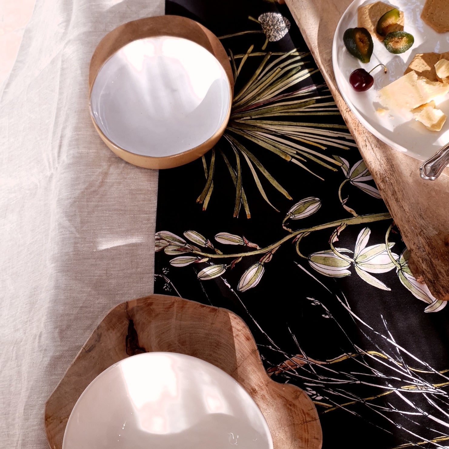 CoralBloom cotton table runner printed with greenery botanicals on black