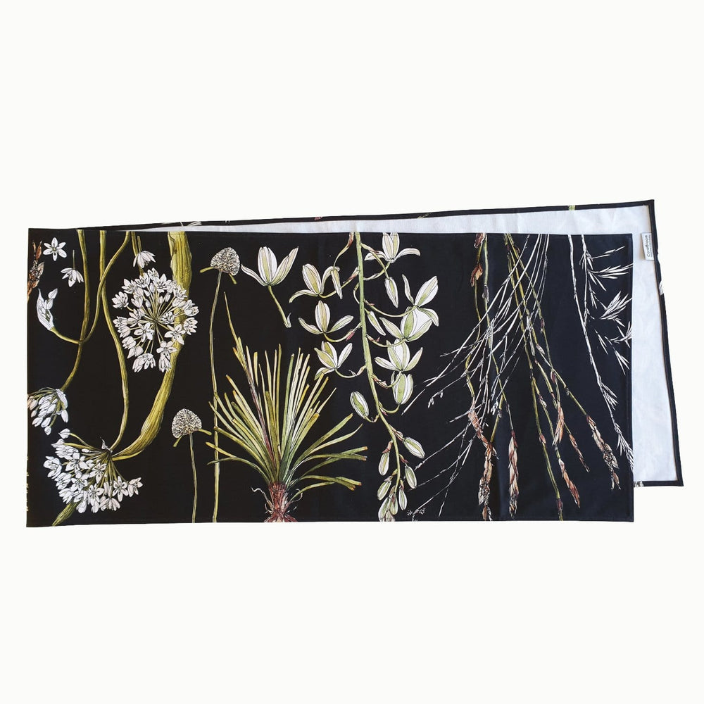 CoralBloom cotton table runner printed with greenery botanicals on black