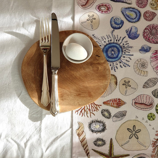 CoralBloom cotton table runner for sale printed with seashells on white